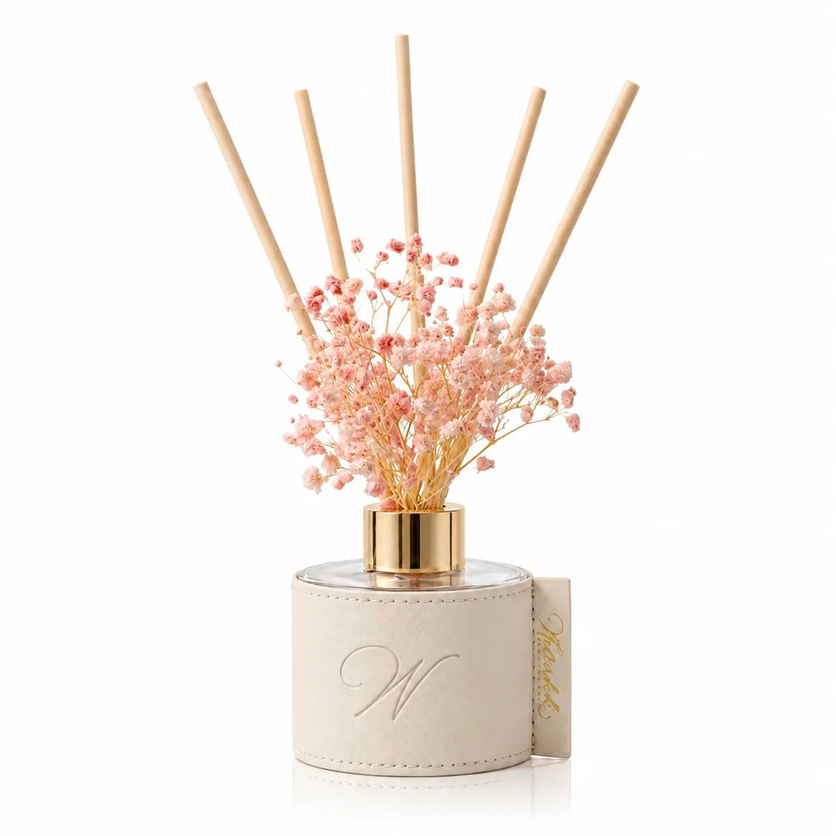 White leather reed diffuser with pink dried flowers and a gold monogram