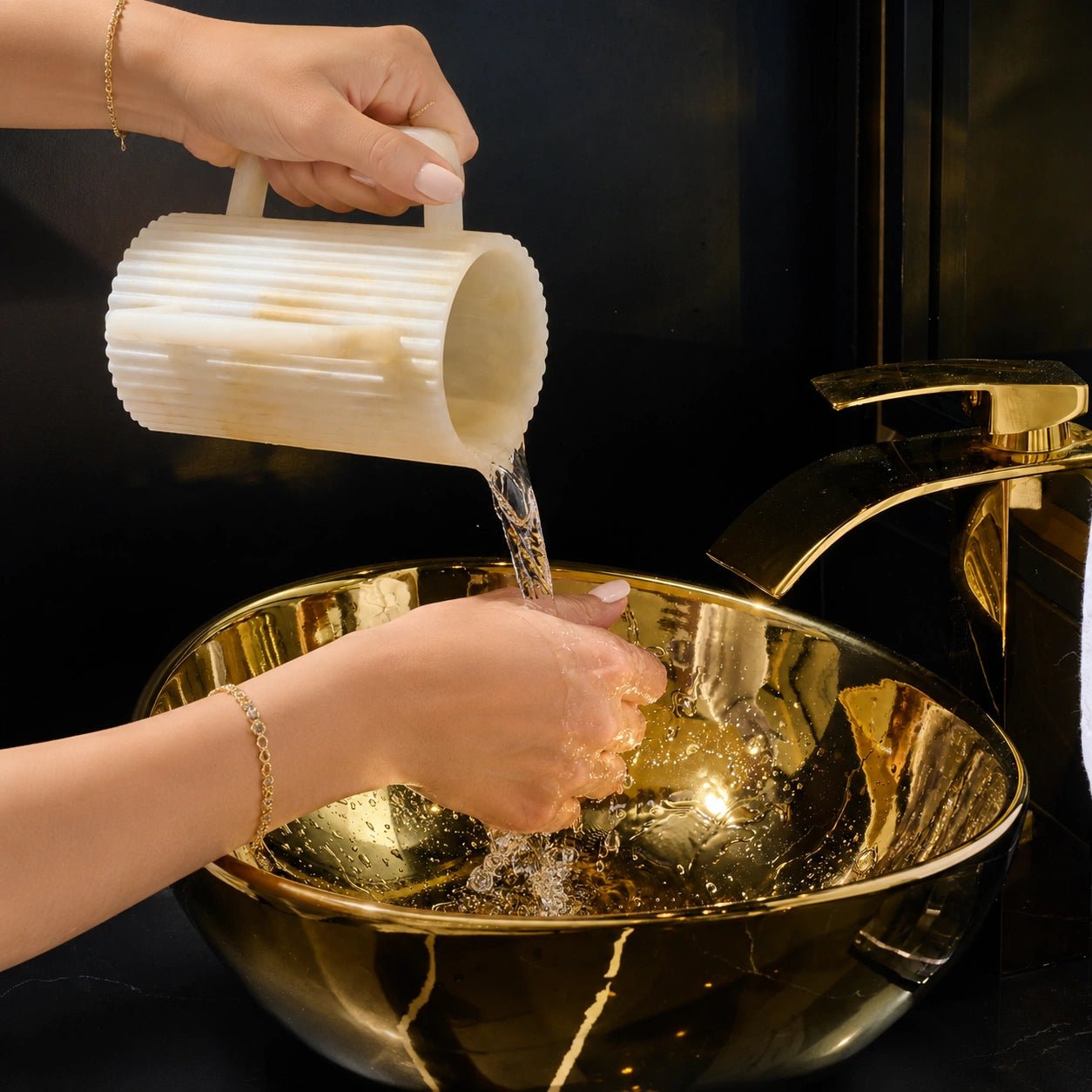 Fluted resin washing cup with two handles for Netilat Yadayim with a person washing their hands in the sink.