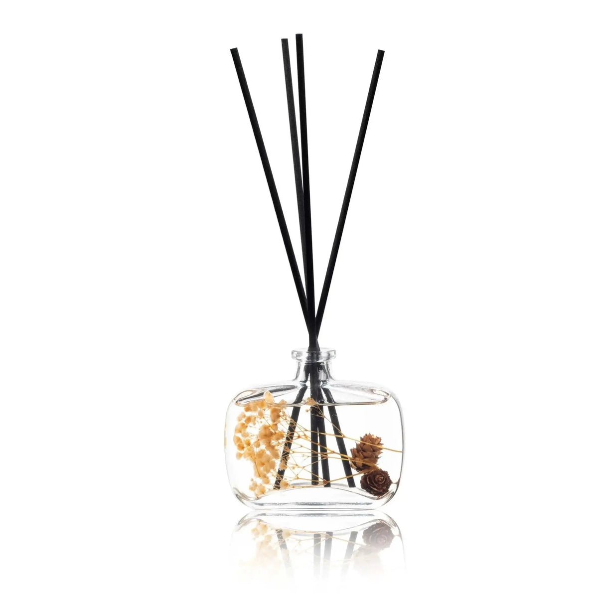 Autumn Diffuser with clear glass bottle containing dried botanicals and three black reed sticks for scent dispersal.