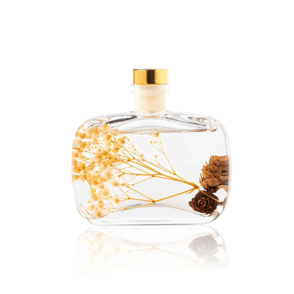Autumn Diffuser by Waterdale Collection with dried flowers and botanicals inside clear glass bottle with gold cap.