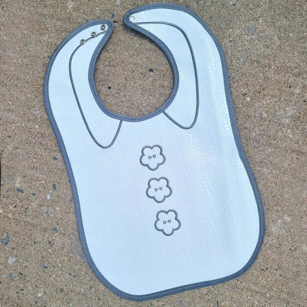 Light blue crocodile patent leather bib with three animal face designs, unisex baby bib with snap closure by Waterdale Collection.