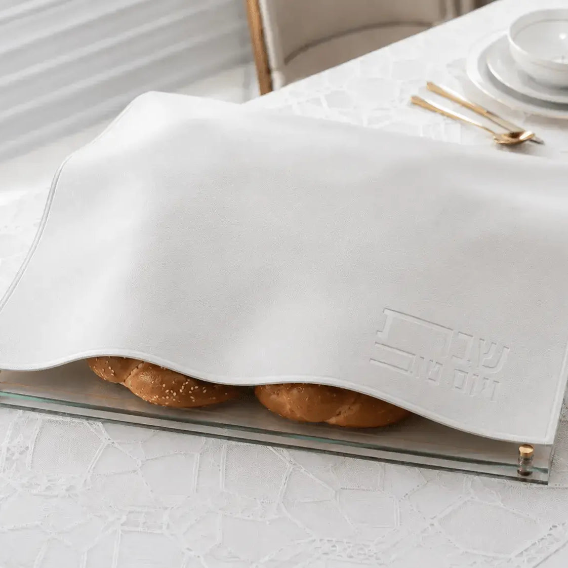 White embossed leather challah cover with gold trim, displayed open to show interior, perfect for Shabbat table settings.