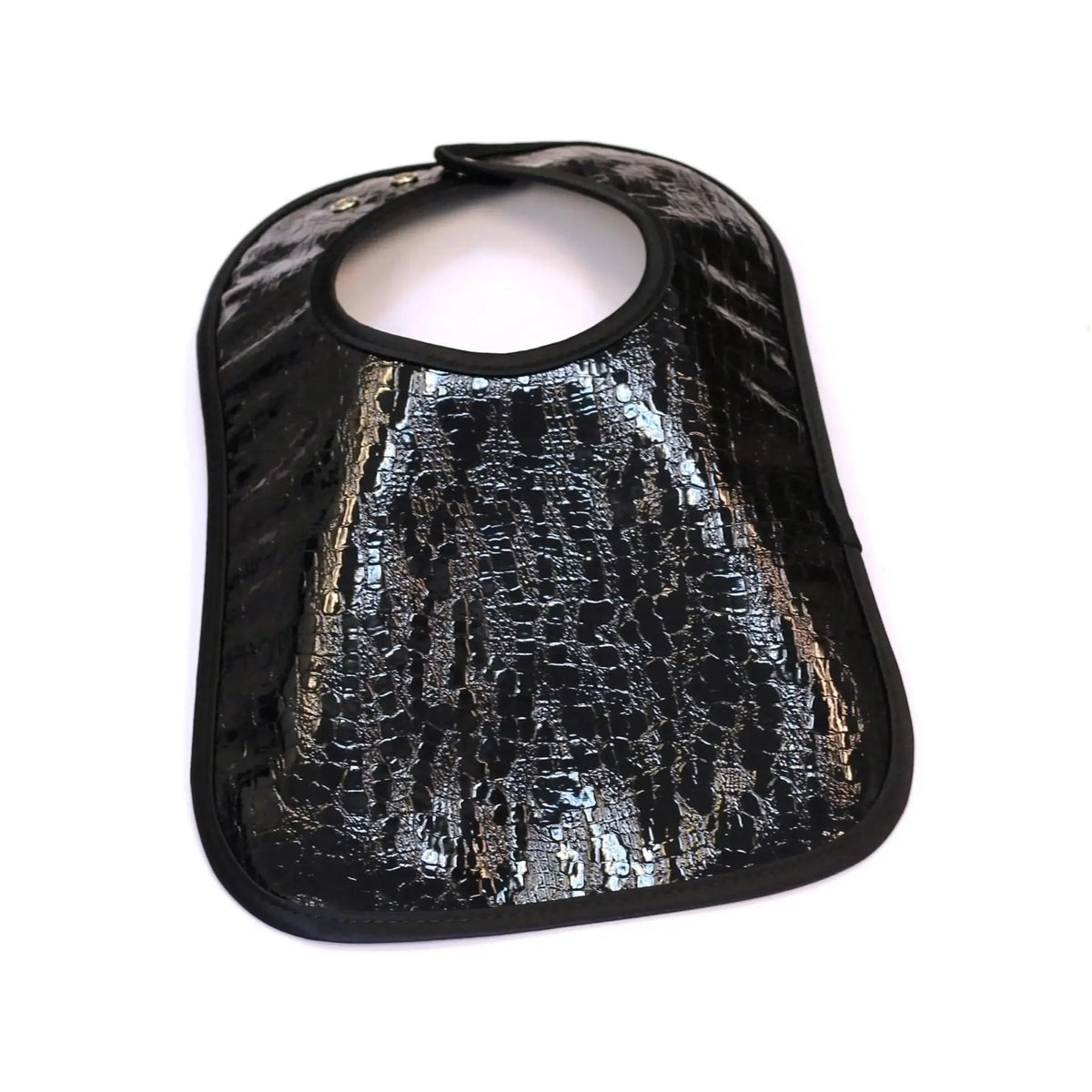 Black crocodile patent leather bib with textured embossed pattern and snap closure, designed for babies and toddlers by Waterdale Collection.