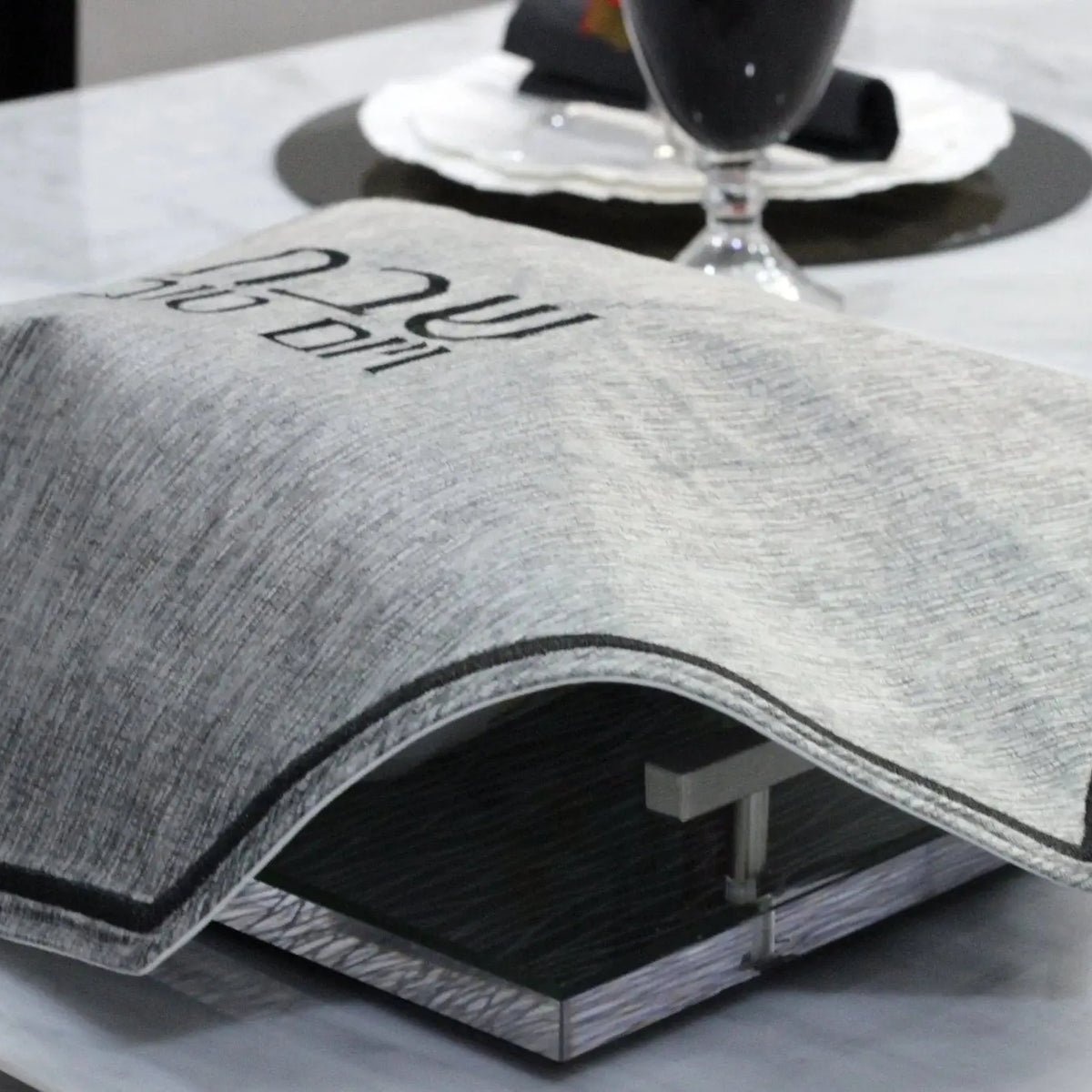 Gray crushed velvet hexagon challah cover with textured fabric detail, displayed flat on white surface for Shabbat table.