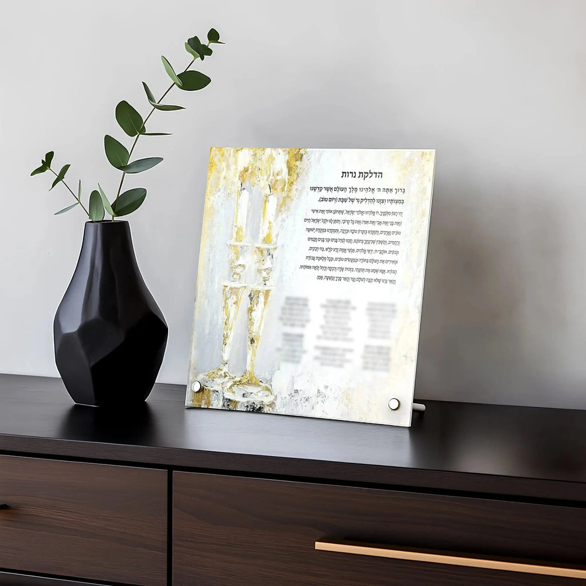 Custom Painted Gold Hadlokas Neiros with Names displayed on tabletop stand beside black vase with eucalyptus branches and prayer card
