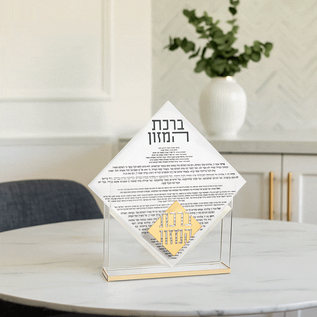 White ceramic Diamond Suspended Bencher Set on round table with plant, gold accents, Jewish prayer book holder for Shabbat and Purim