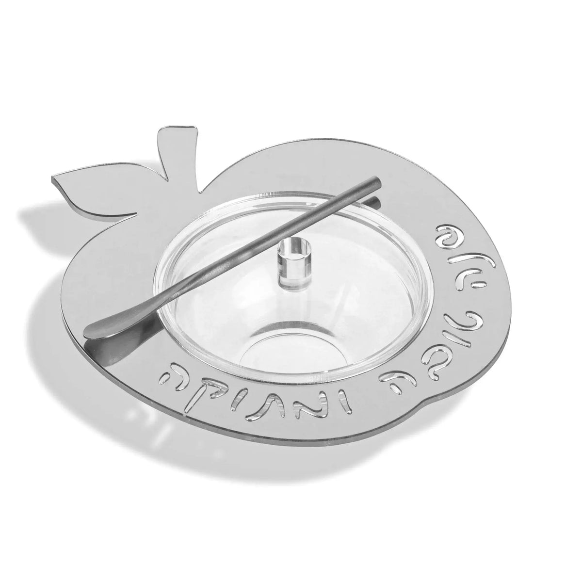 Silver floating apple honey dish with a metal spoon for a Rosh Hashana table (ראש השנה)