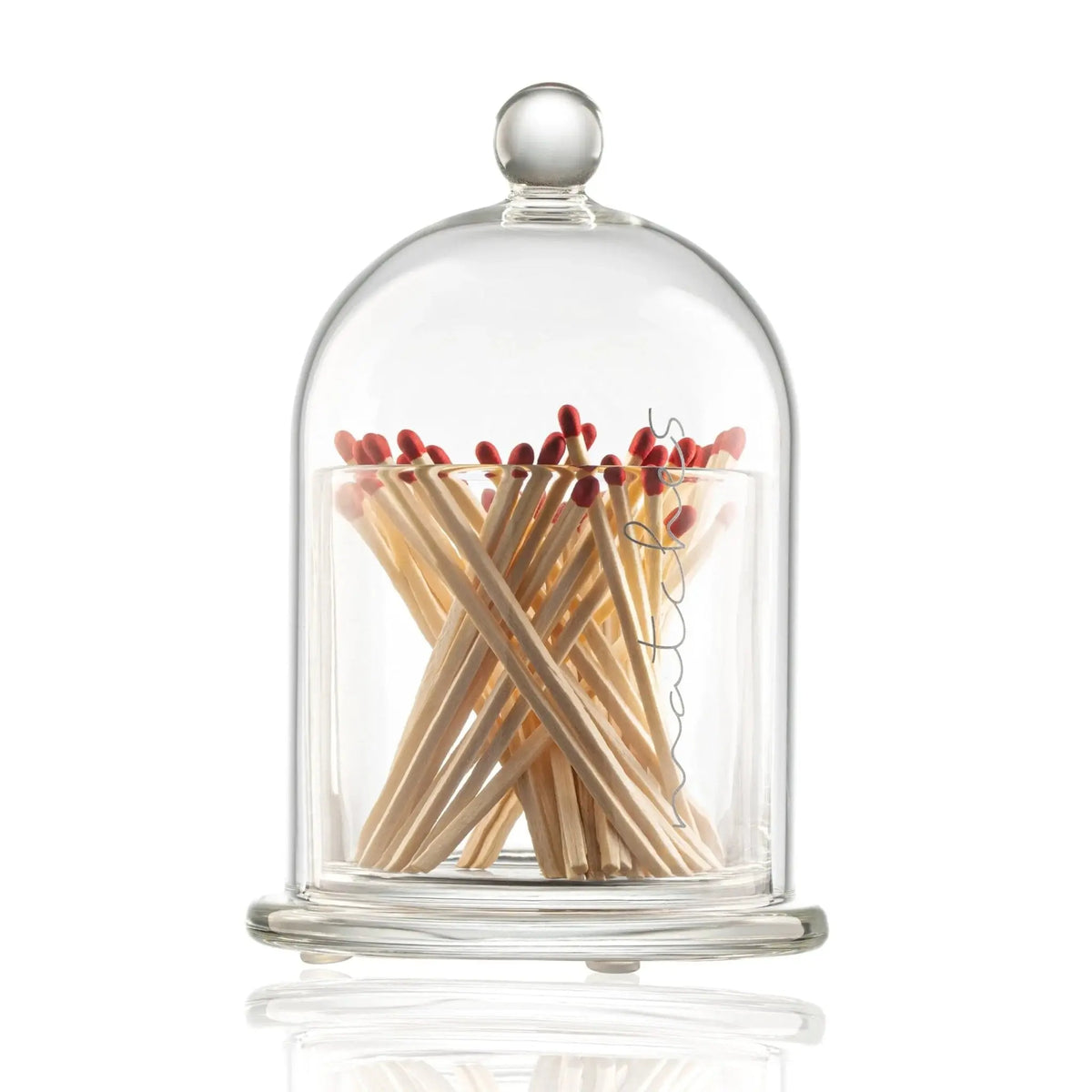 Glass cloche match holder with wooden matches featuring red tips arranged in a crisscross pattern, elegant dome design perfect for Shabbat and candle lighting.