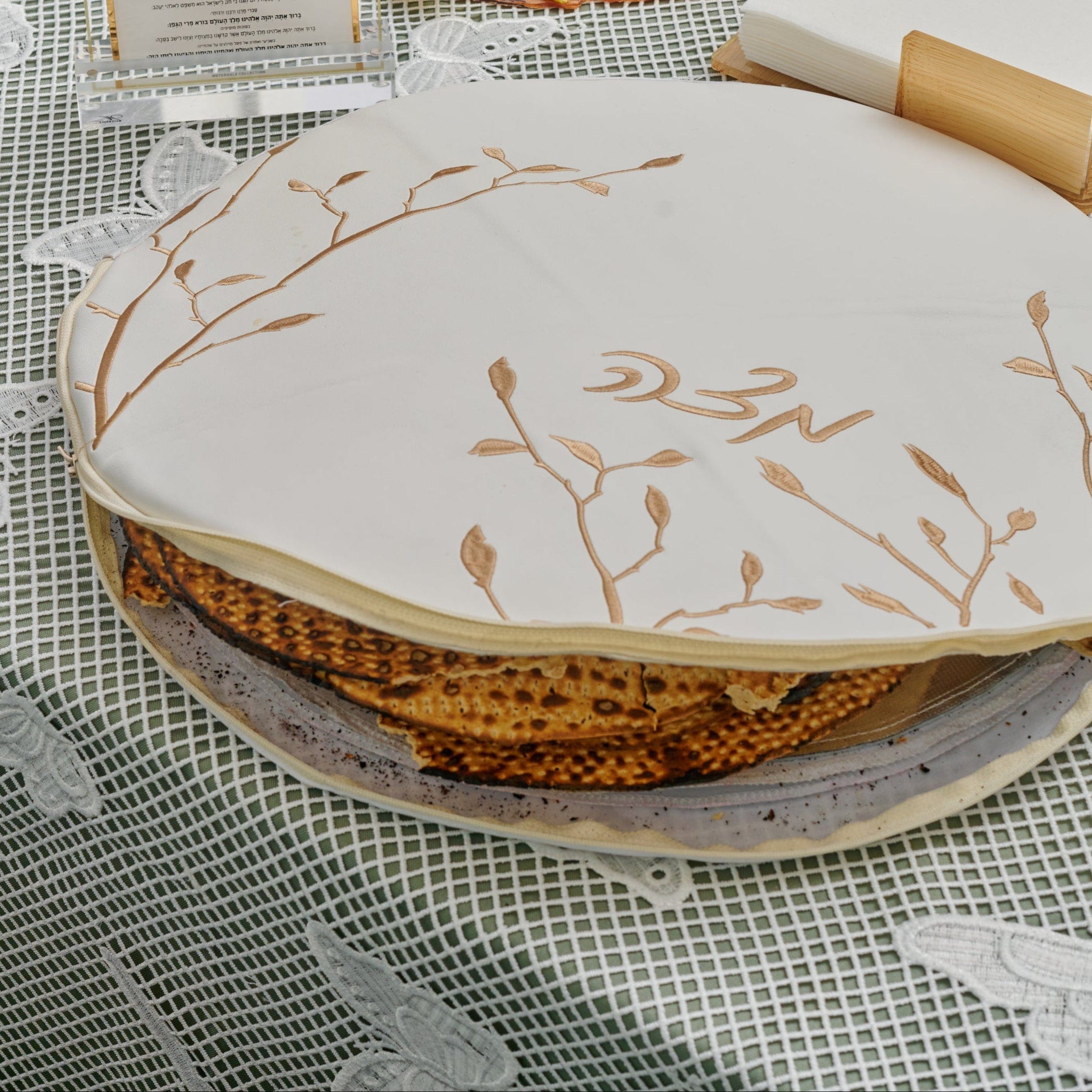 Insulated Leaf Embroidered Gold Matzah Pouch Cover with Pesach Bread on a Pesach Table | Waterdale Collection