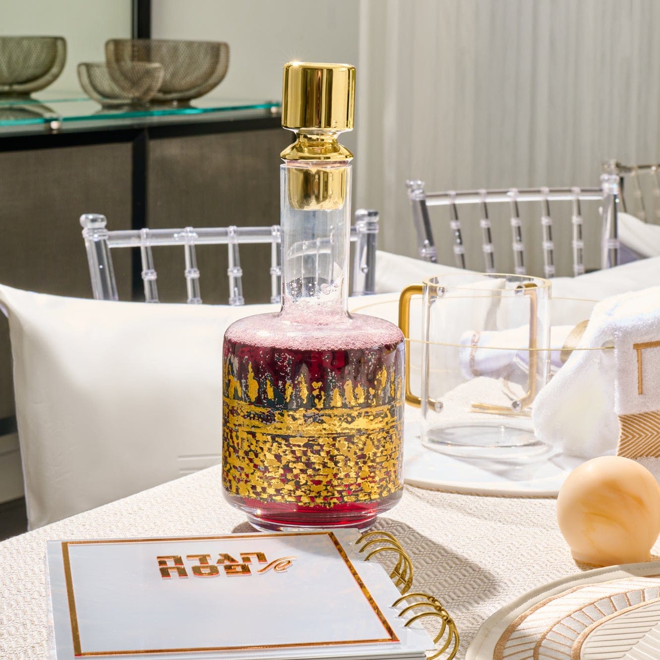 Kosel at Winter Wine Decanter featuring rich red glass with gold Jerusalem skyline detailing and sleek gold stopper, luxury Judaica wine bottle for Shabbat and Yom Tov.