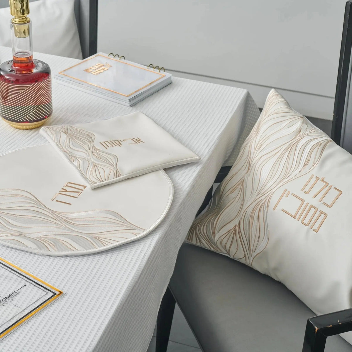 Lace Pesach set with gold and white placemats and napkins arranged on table with plate and tableware