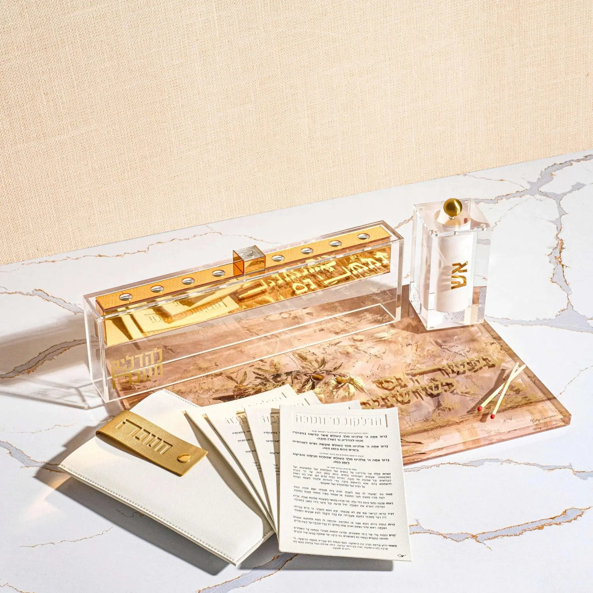 Chanukah brachos cards fanned beside their gold leather pouch, the full blessings printed for Hanukkah candle lighting