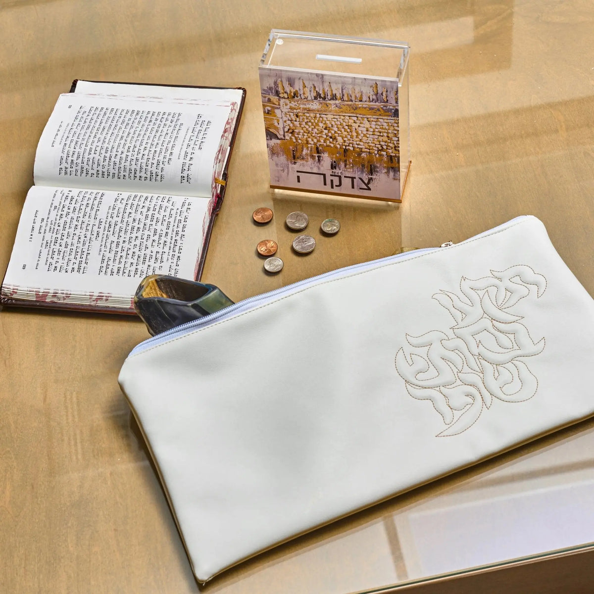 White leather shofar bag styled with a machzor for the High Holidays