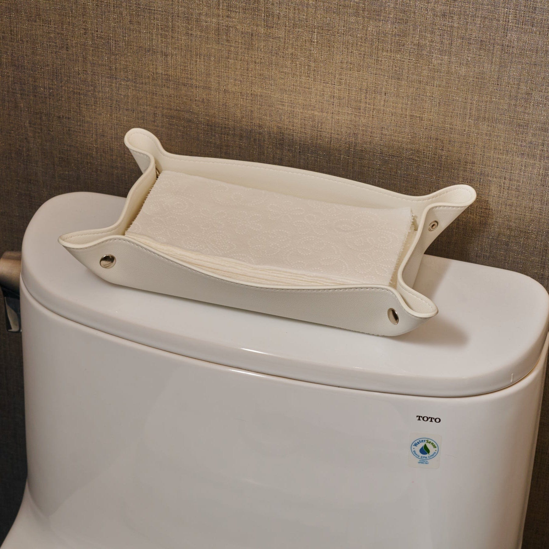 White Leather Shabbos Toilet Paper holder displayed on a toilet tank of a modern bathroom