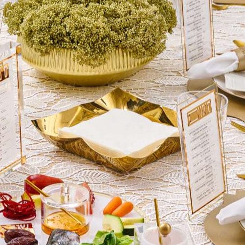 Gold Metal Contour Napkin Holder on a table top | Waterdale Collection