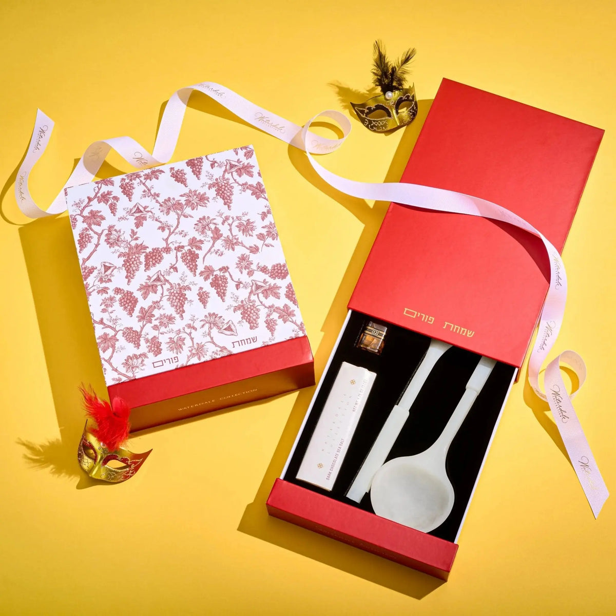 Resin salad servers in black and white striped pattern with red gift box and yellow ribbon on yellow background, Purim mishloach manos gift set