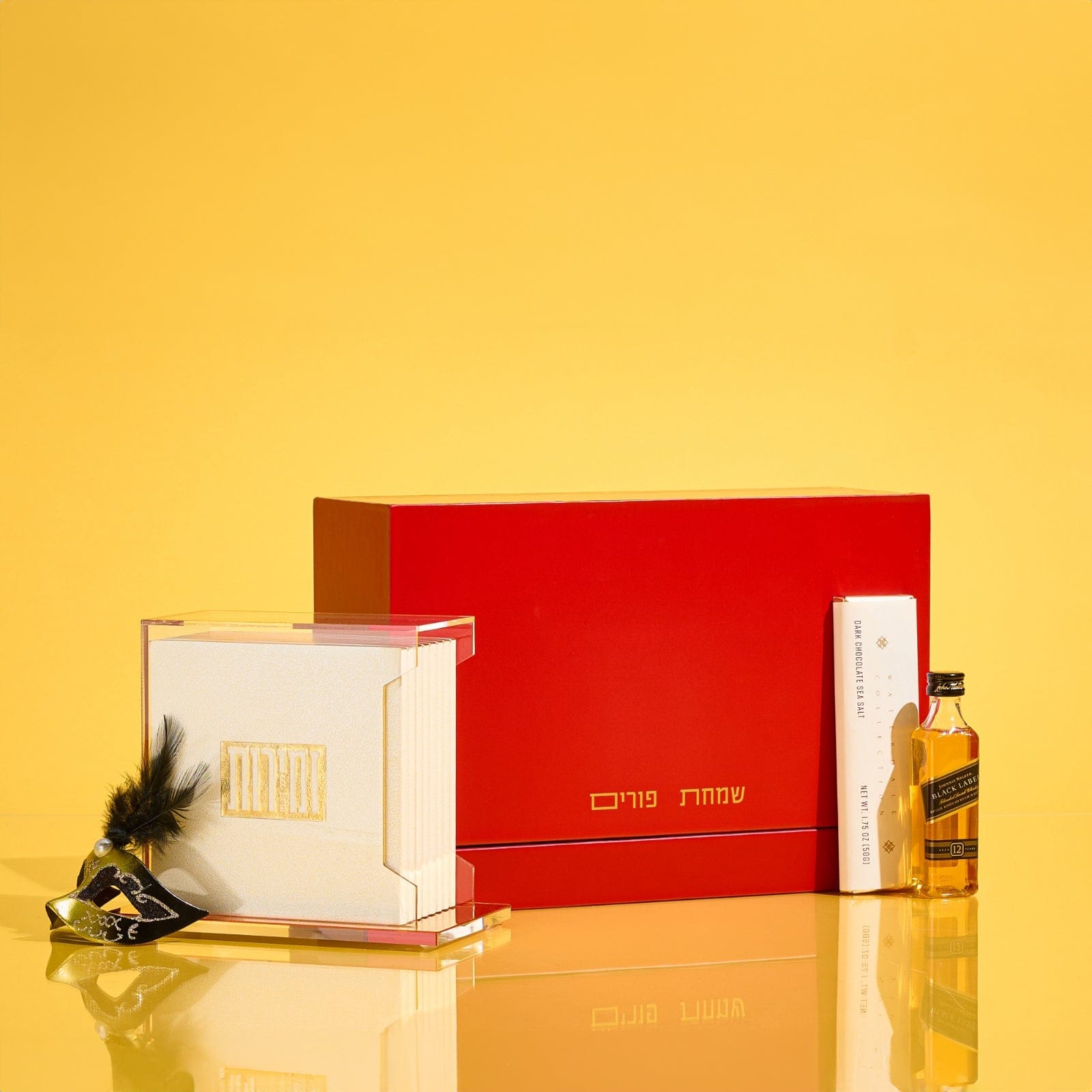 Elegant Mishloach Manot gift basket for Purim featuring premium wine, Hebrew-themed Judaica, and deluxe gift boxes