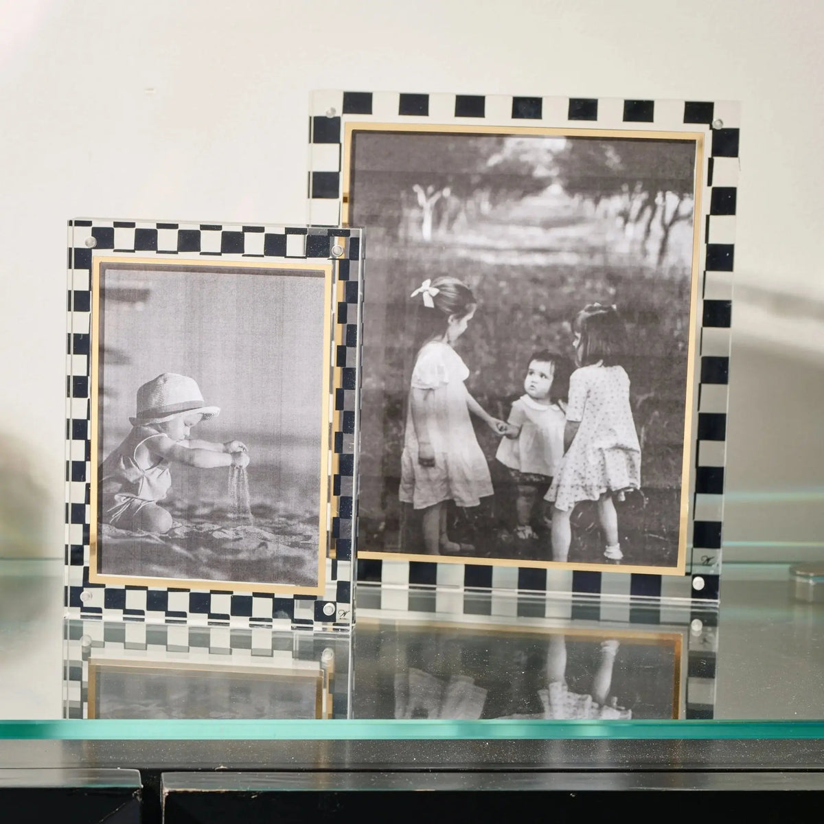 Waterdale Collection onyx picture frame with black and white checkered border displaying family photos on tabletop.