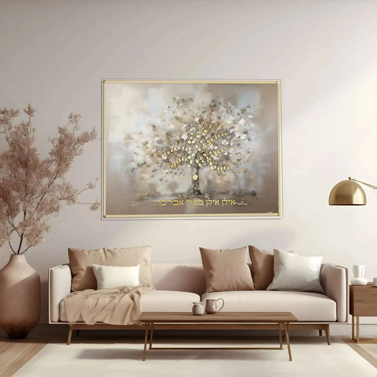 Painted by Batya abstract family tree wall art hanging above a beige sofa with gold accents in a modern living room