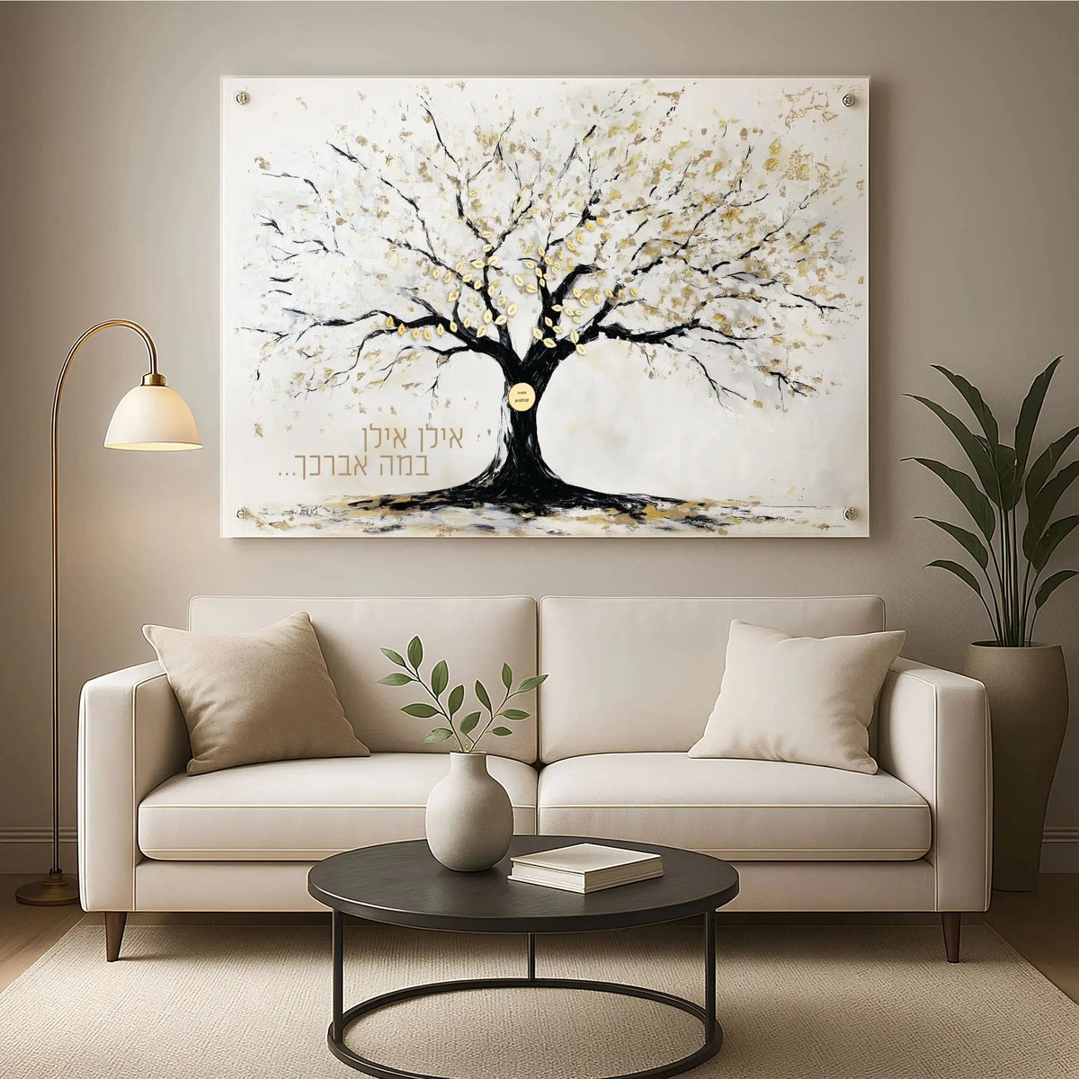 Painted by Batya White Family Tree artwork displayed above a cream sofa, featuring a black tree with spreading branches on white canvas for modern home decor.