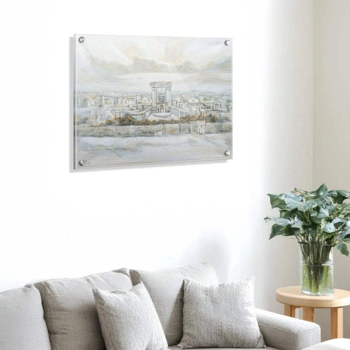 Watercolor painting of the Second Temple in Jerusalem displayed above a gray linen sofa with white flowers on side table