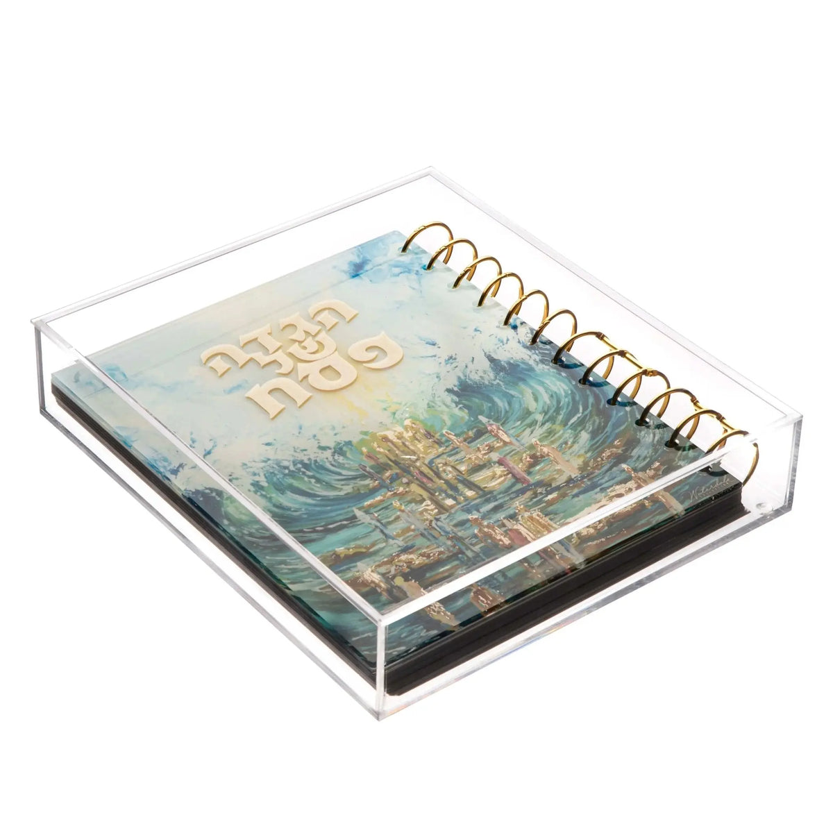 Painted Traditional Haggadah with watercolor artwork showing coastal landscape, housed in clear lucite case with gold spiral binding, by Waterdale Collection.