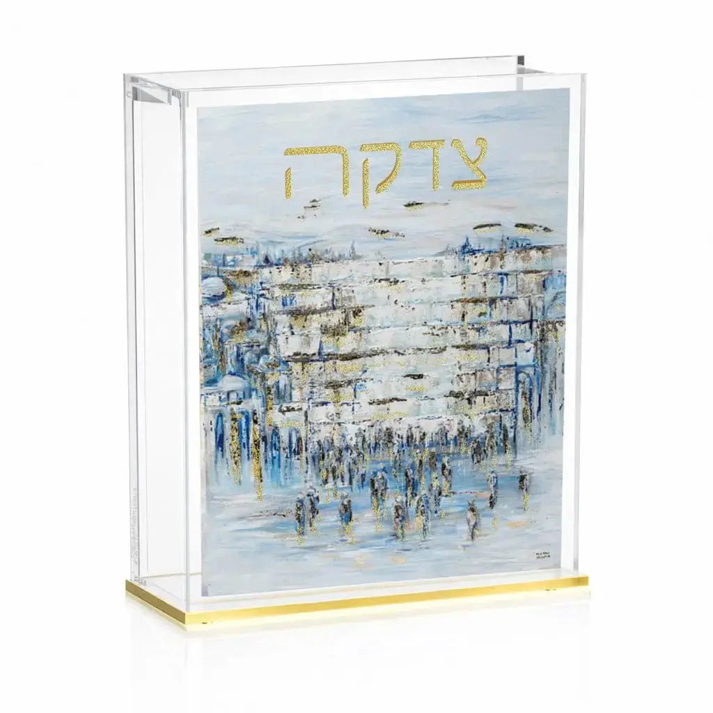 Painted Yosefa Kosel Tzedakah Box with Western Wall scene in blue and gold tones, displayed in clear acrylic case with brass base.