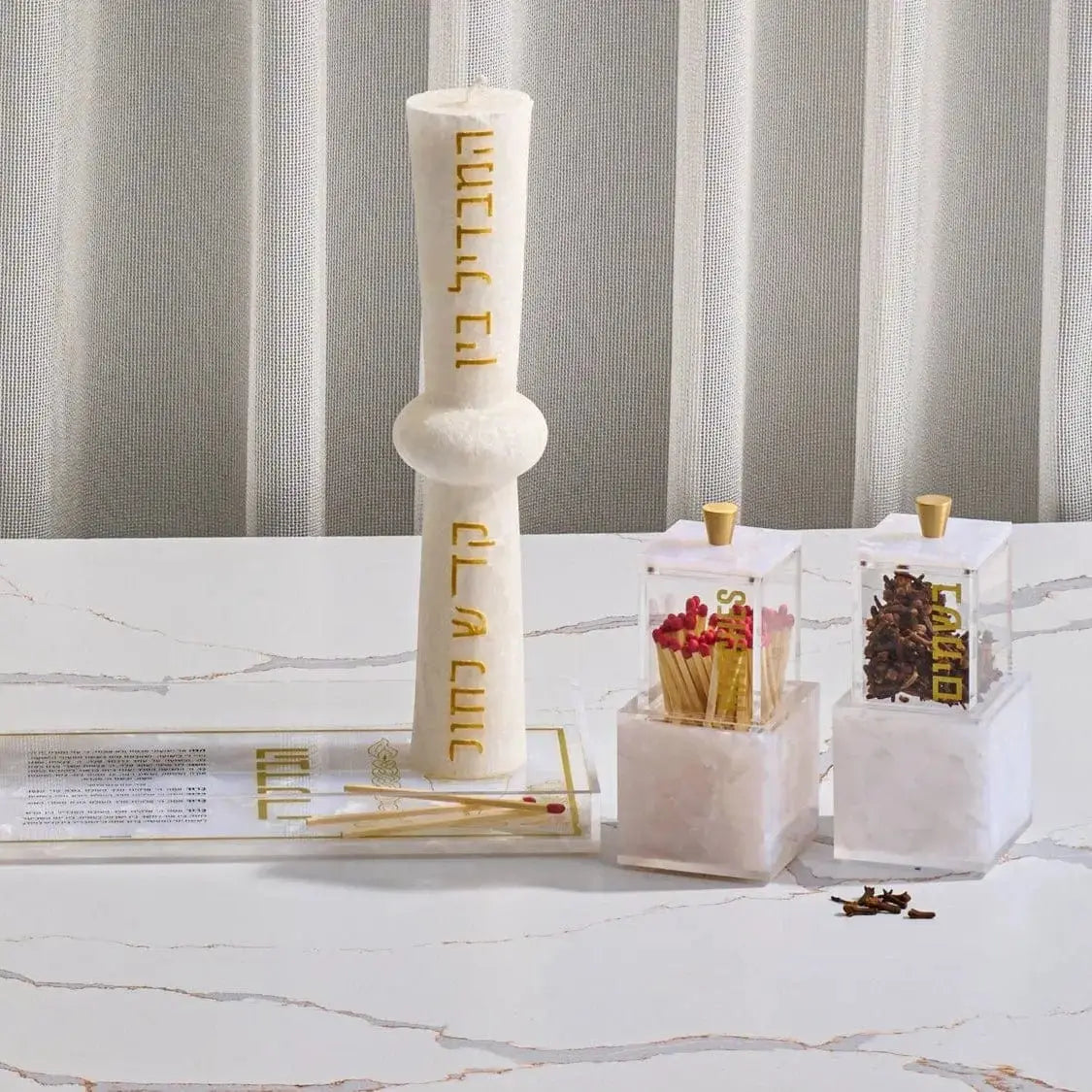 Pearlstone Block Besamim Jar with white marble finish and gold-tone metal tower top, displayed with spice containers for Havdalah and Shabbat use.