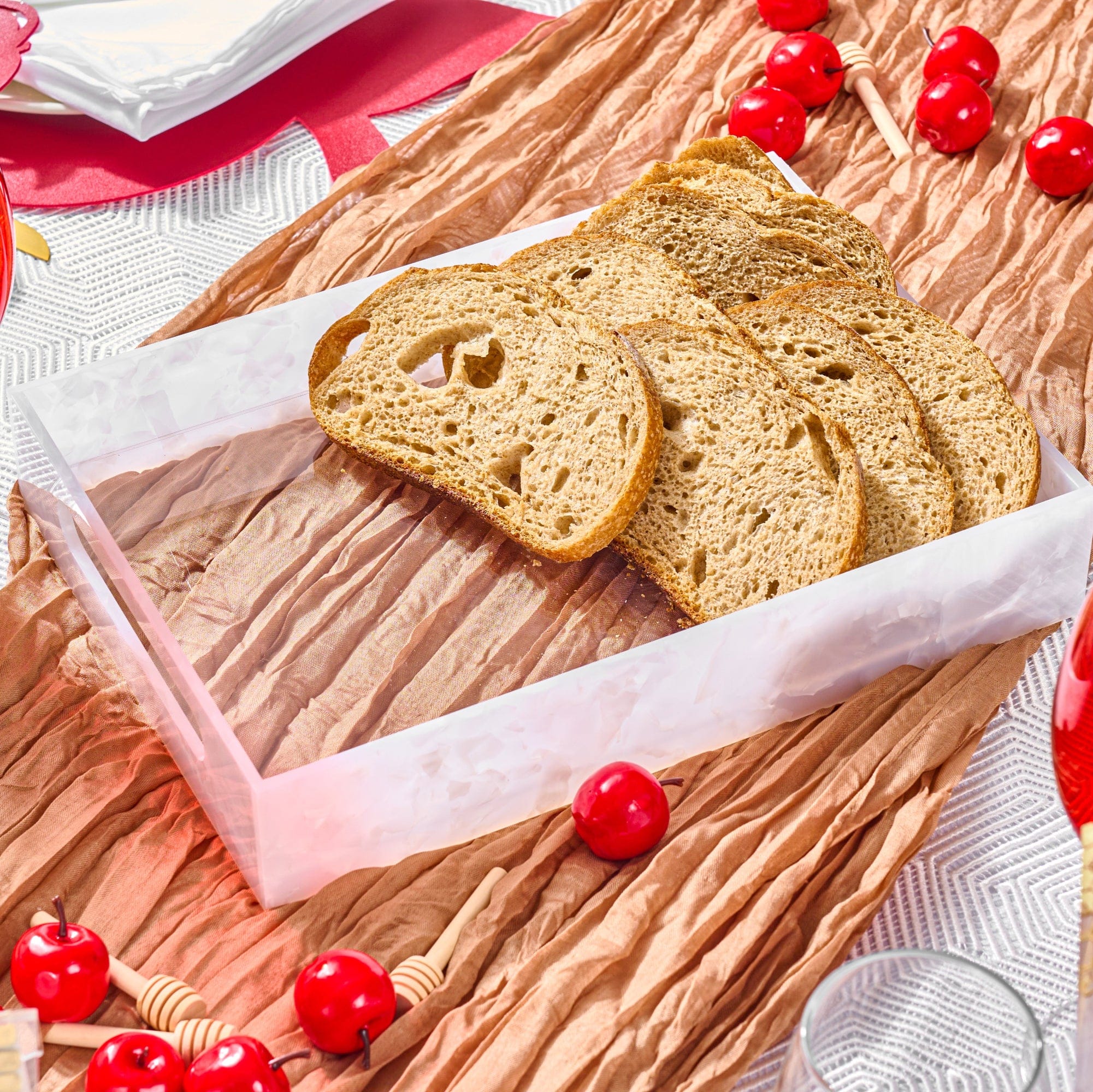 Pearlstone Serving Tray on an elegant holiday table decorated with honey dippers and red accents.