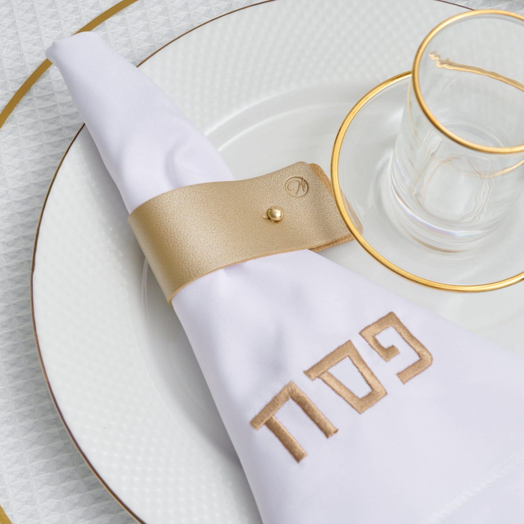 Gold Pin Leather Napkin Wraps on a gold accent tableware in a table setting