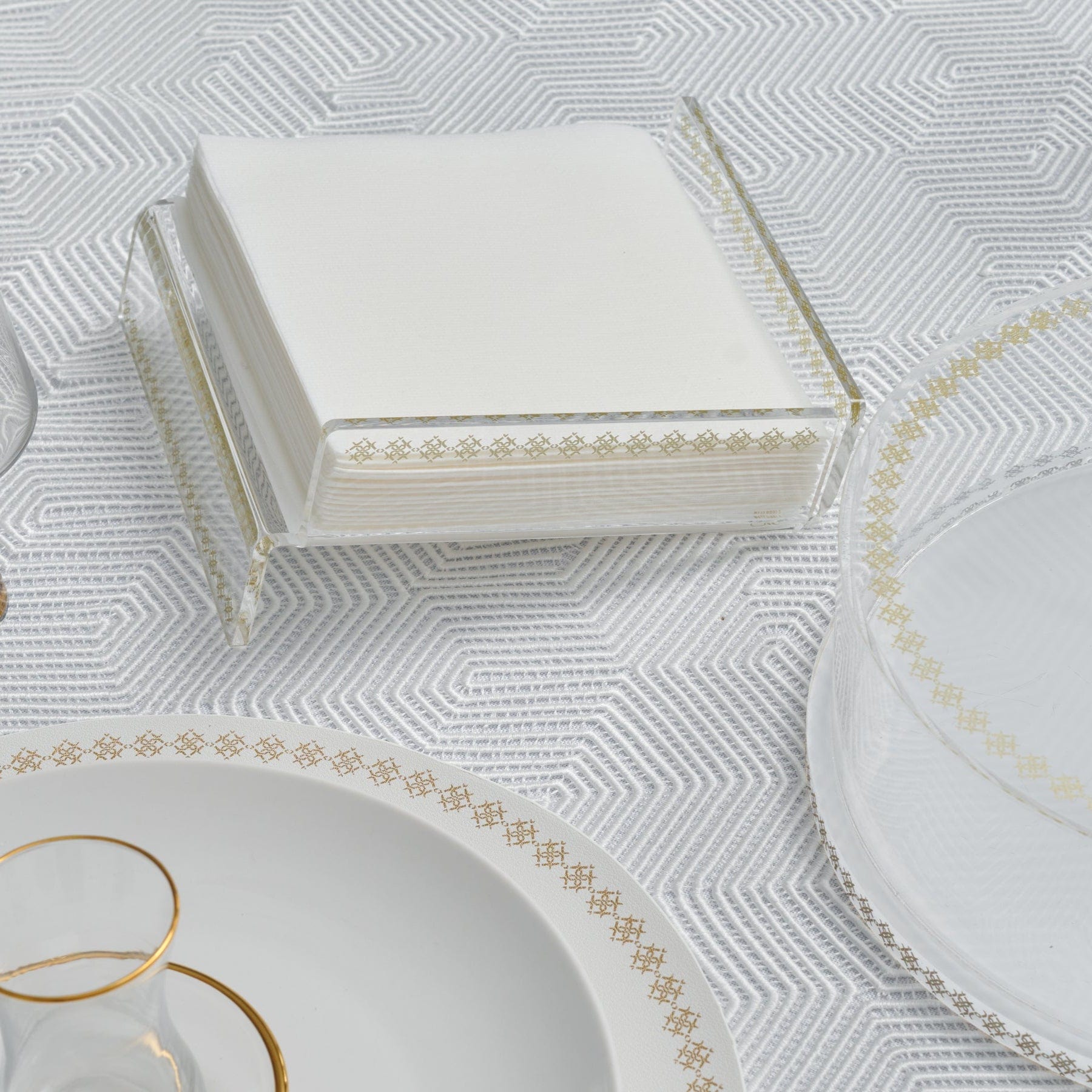 Raised Inspired Napkin Holder on a modern geometric tablecloth.