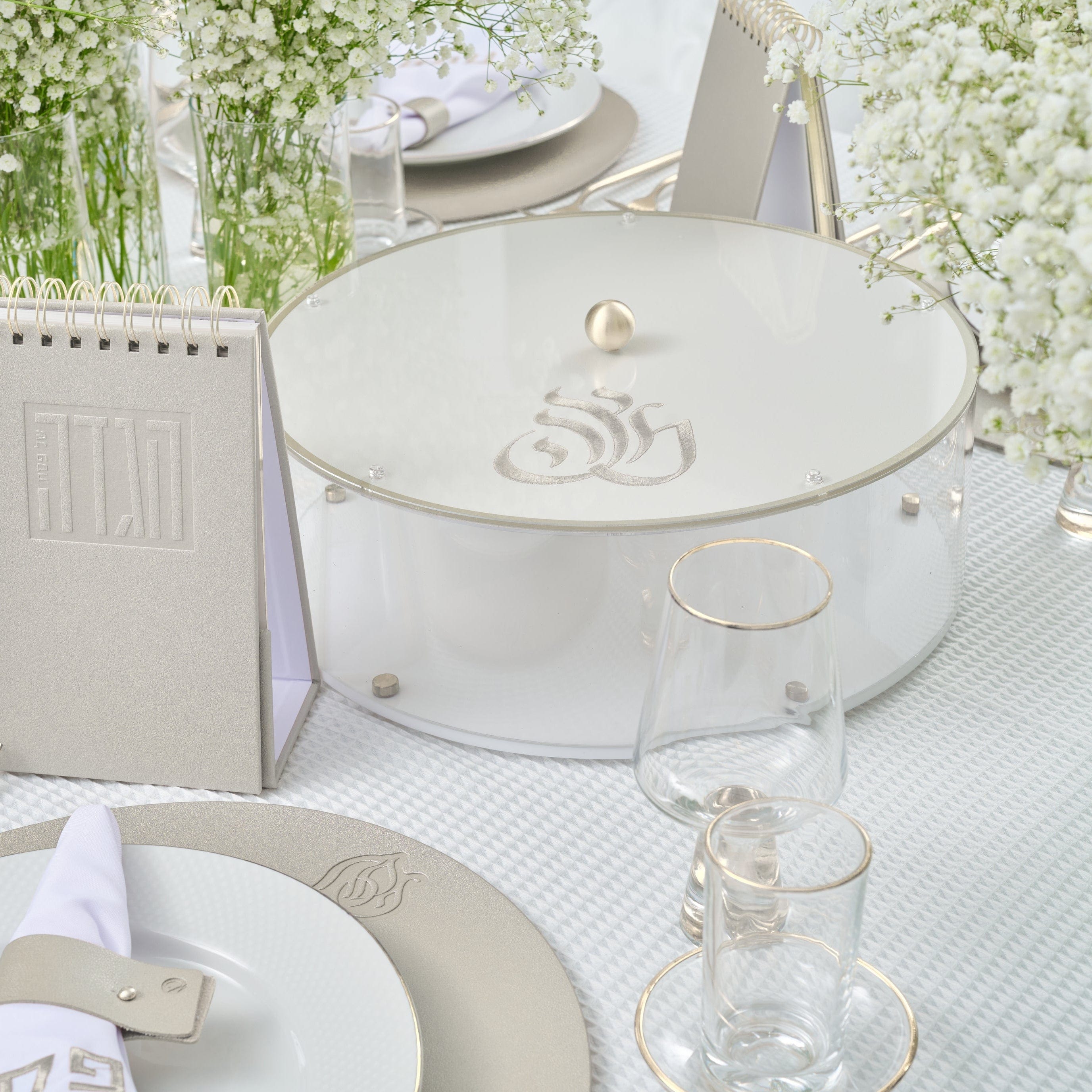 Regal Matzah Box with silver accents and elegant script detail displayed on a white and silver Passover table