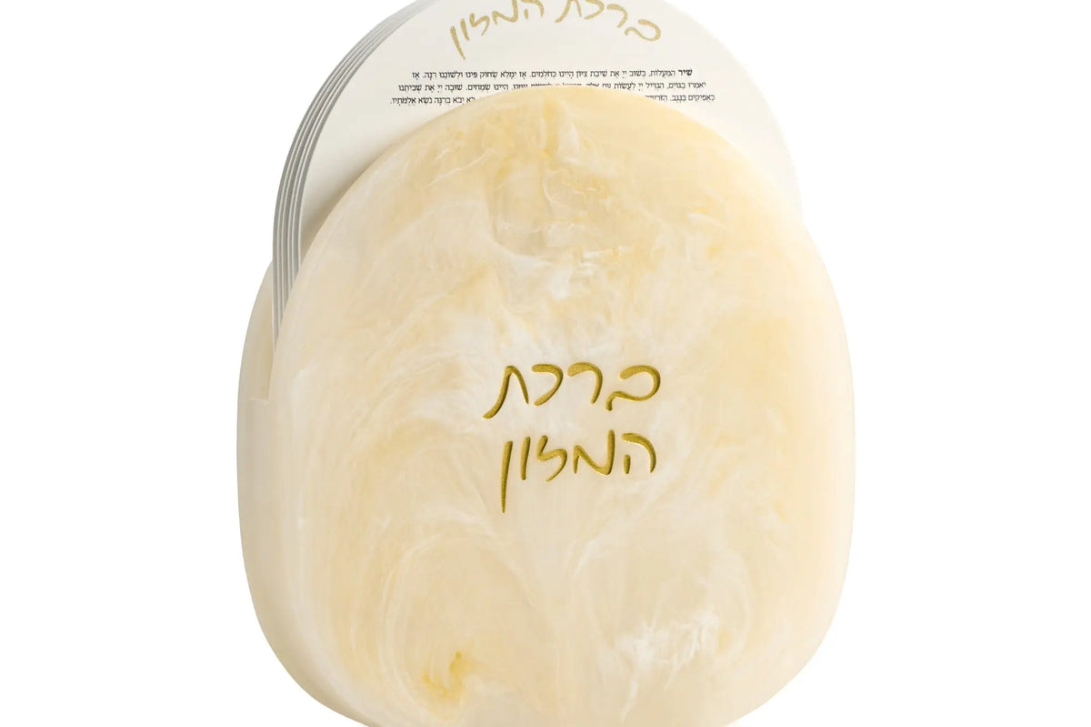 Cream-colored resin bencher set with Hebrew text, elegant tabletop design for Shabbat and holiday entertaining.