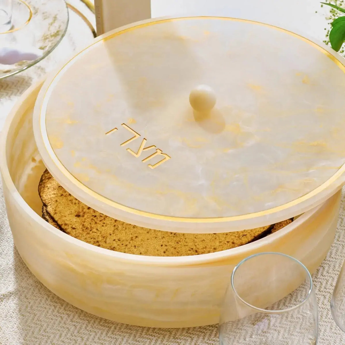 Cream-colored resin matzah box with clear lid by Waterdale Collection, displaying stacked matzah inside, ideal for Pesach tabletop display.