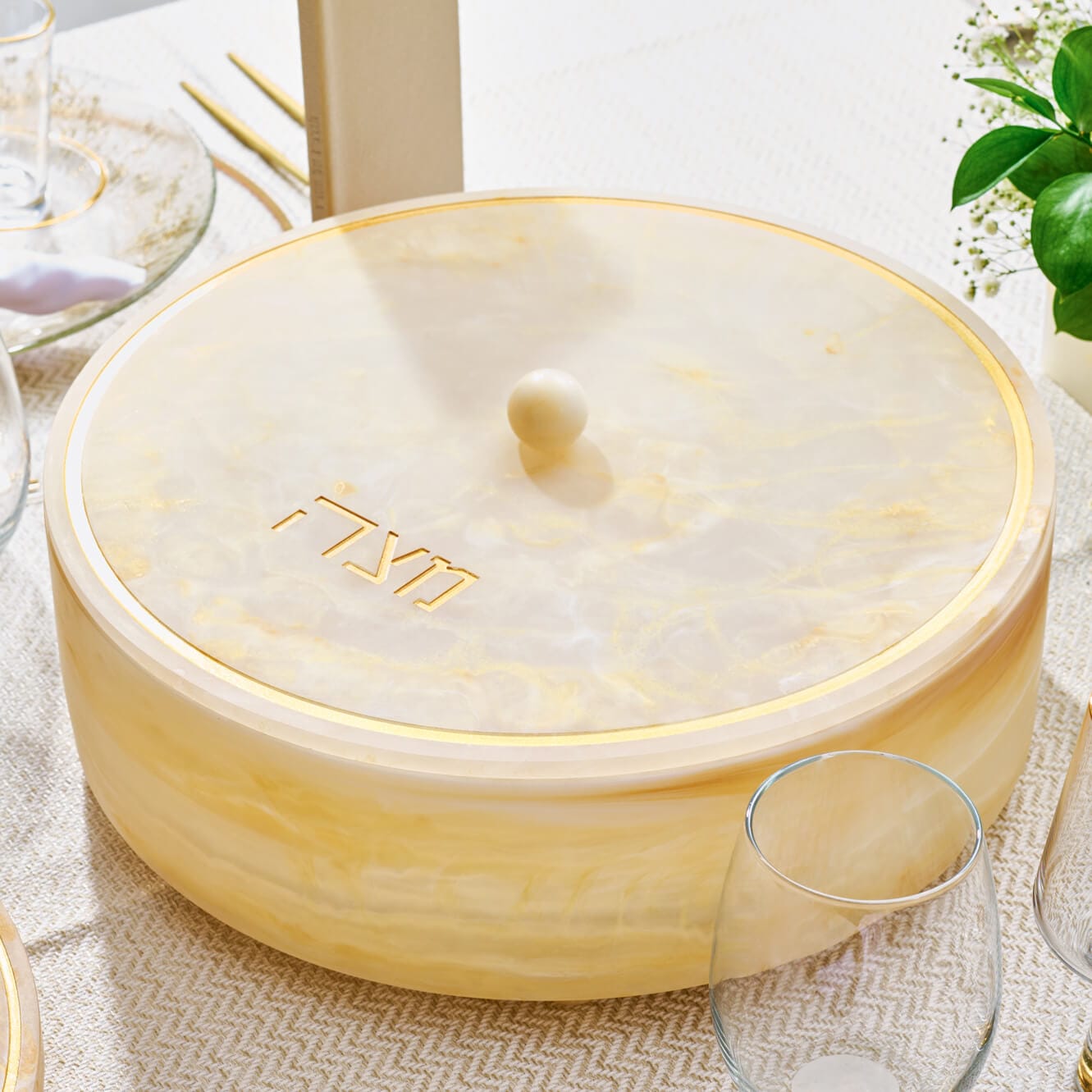 Resin Matzah Box with marble-look finish and gold Hebrew 'Matzah' lettering, elegant Judaica tableware for Passover.