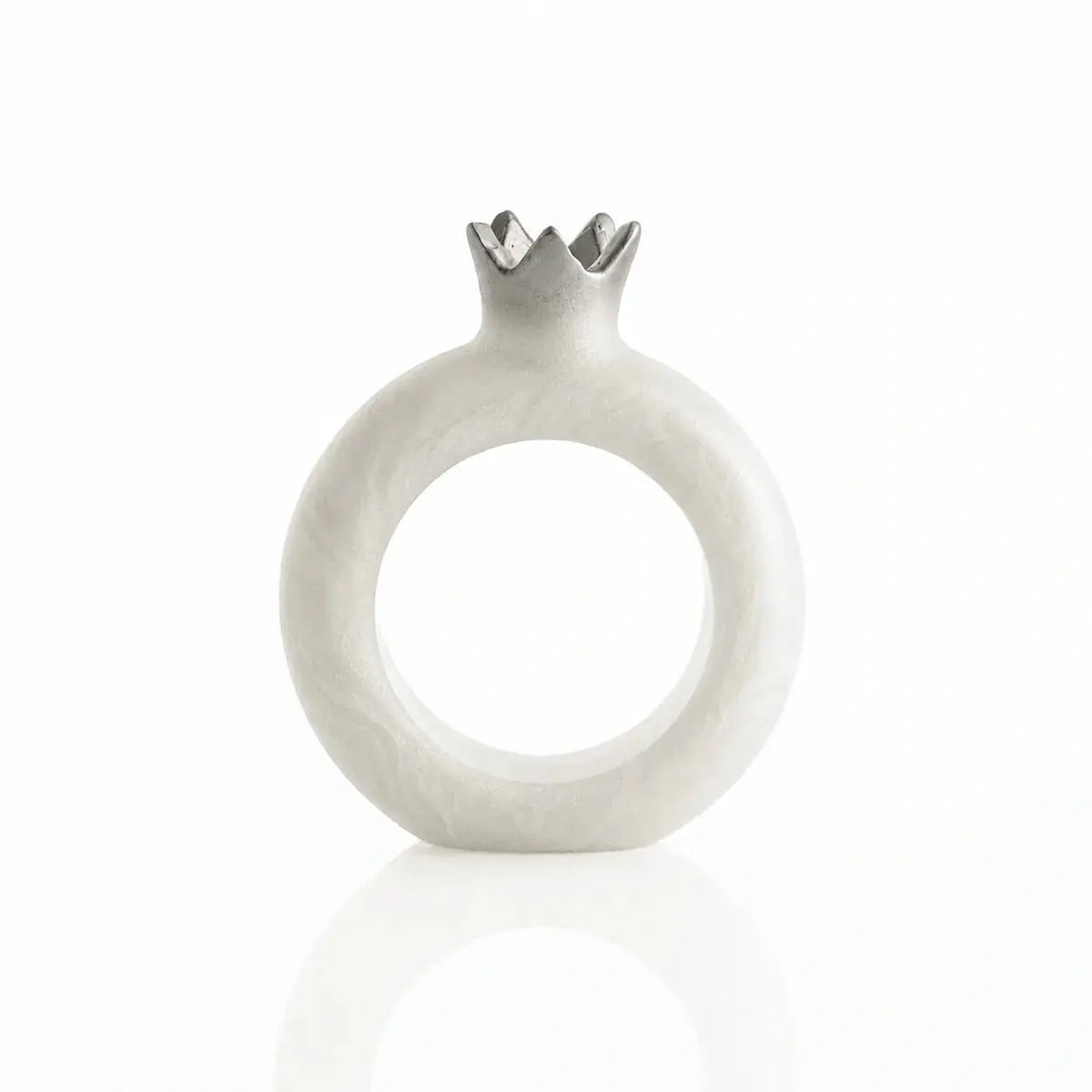 Silver resin pomegranate napkin rings framing napkins at each seat