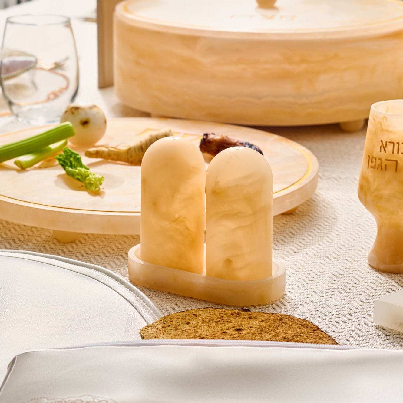 Beige marble-style resin salt shaker set with tray styled on an elegant Seder table setting – Waterdale Collection