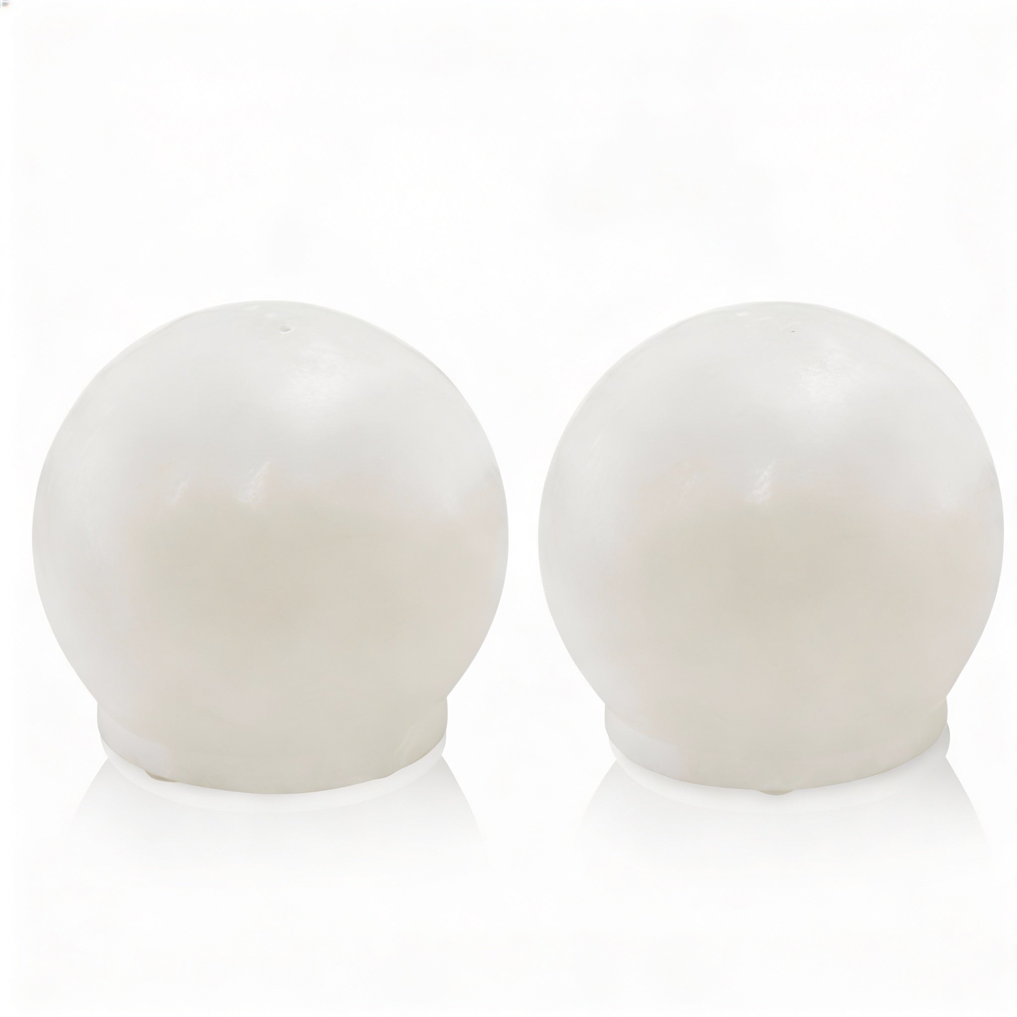 Contemporary neutral resin salt shakers featuring a minimalist silhouette and a smooth, matte finish for modern Shabbat and holiday table decor.