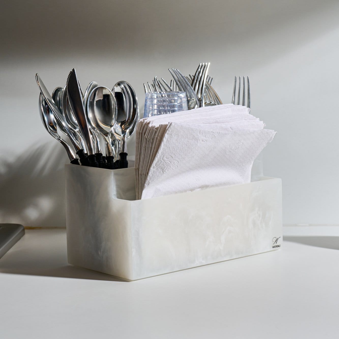 Resin Silverware Caddy with marble-look finish, multi-compartment organizer for cutlery and napkins.