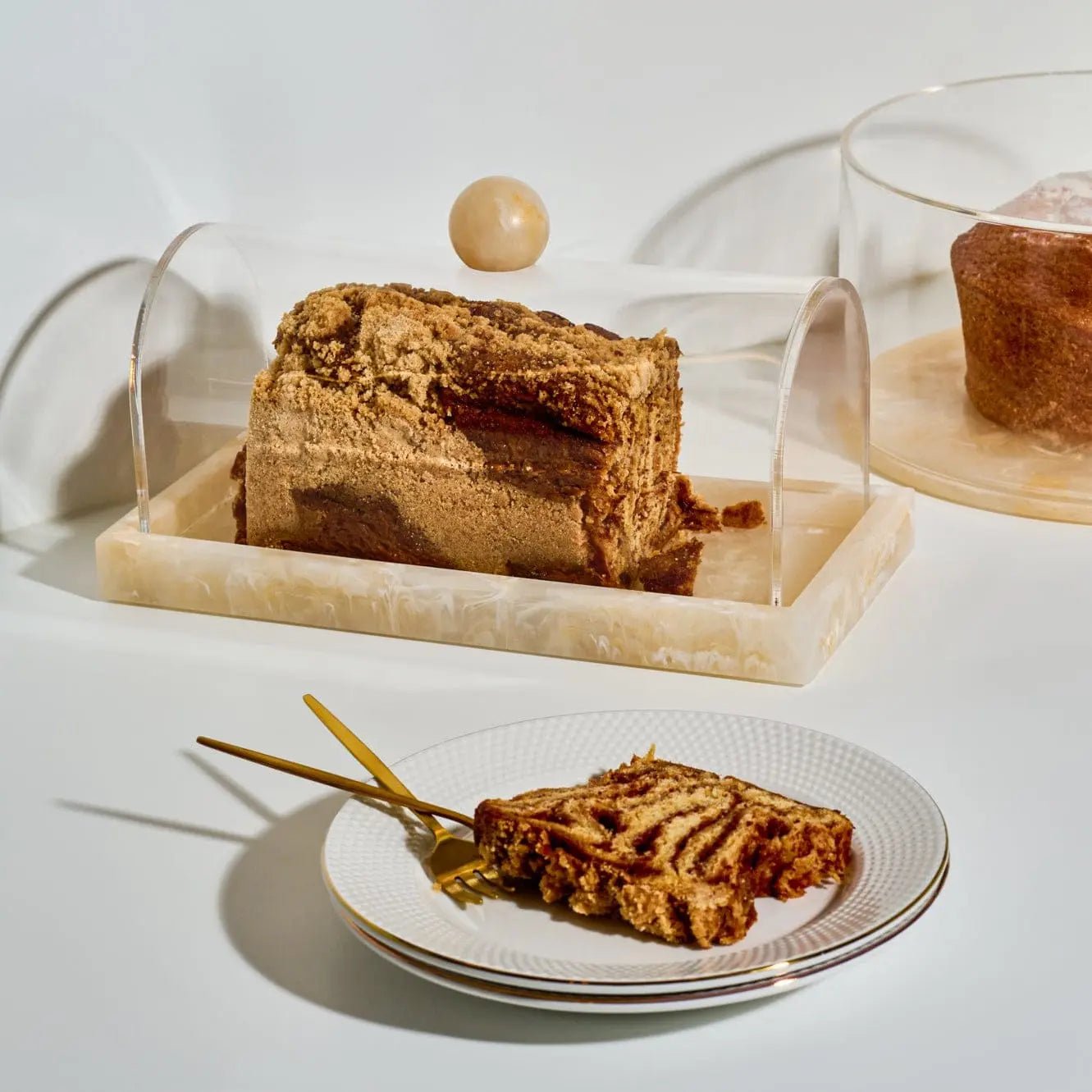Small rectangular resin cake dome displaying cake on an elegant table setting – Waterdale Collection