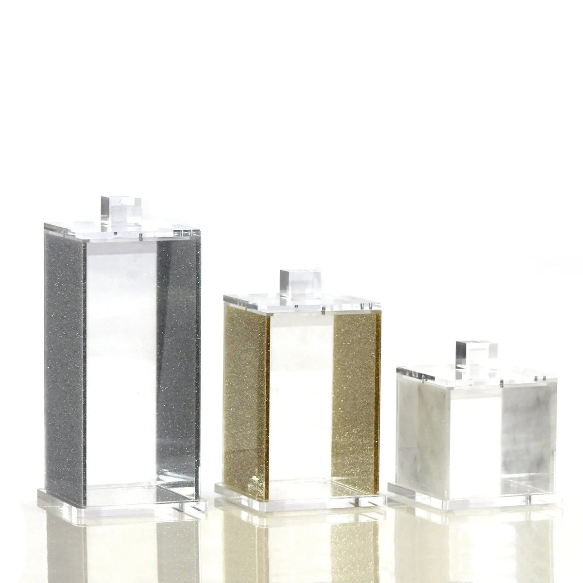 Three square canisters in varying sizes from the Waterdale Collection, featuring marble-textured finishes in gray, olive, and cream tones for kitchen storage.