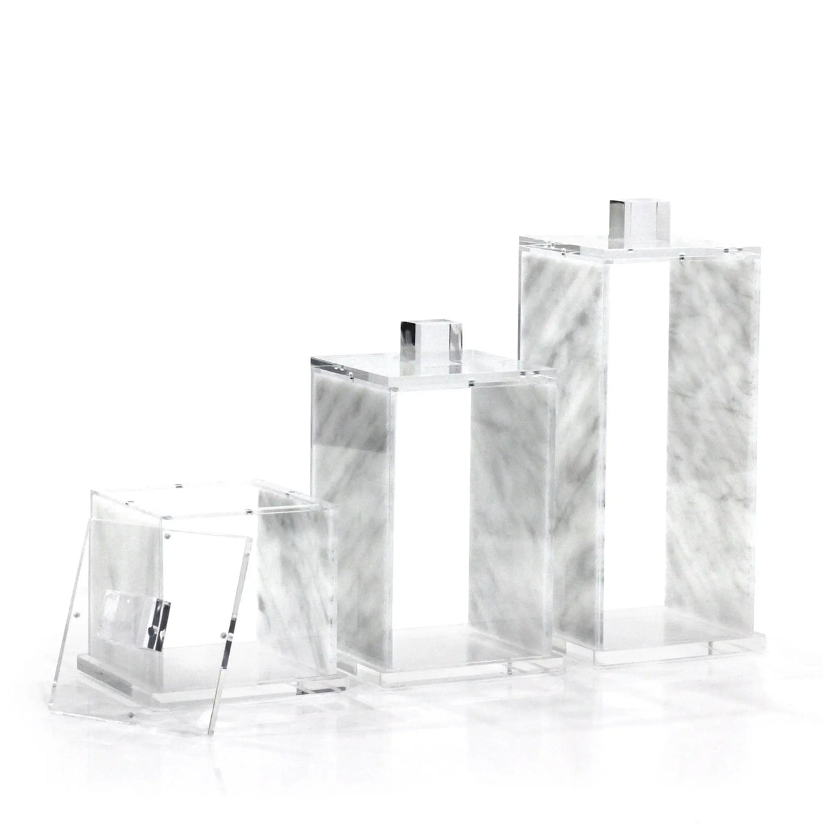 Three square canisters in varying sizes with marble texture and glitter detail, displayed in a product lineup from smallest to largest.
