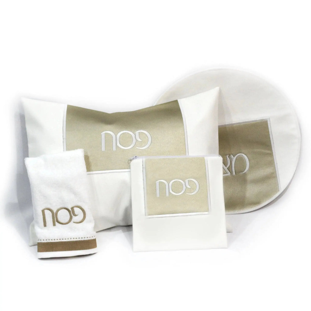 Square Pesach Set by Waterdale Collection featuring white leather dishes with gold accents, displayed with matching tableware accessories for holiday dining.