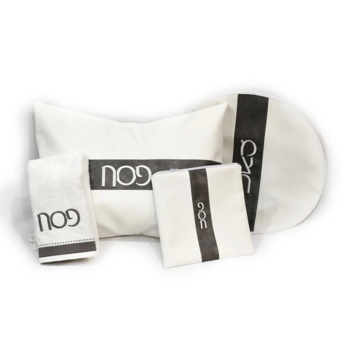 Waterdale Collection Stripe Pesach Set featuring white leather items with black stripe accents, including placemats and matching accessories for holiday table settings.