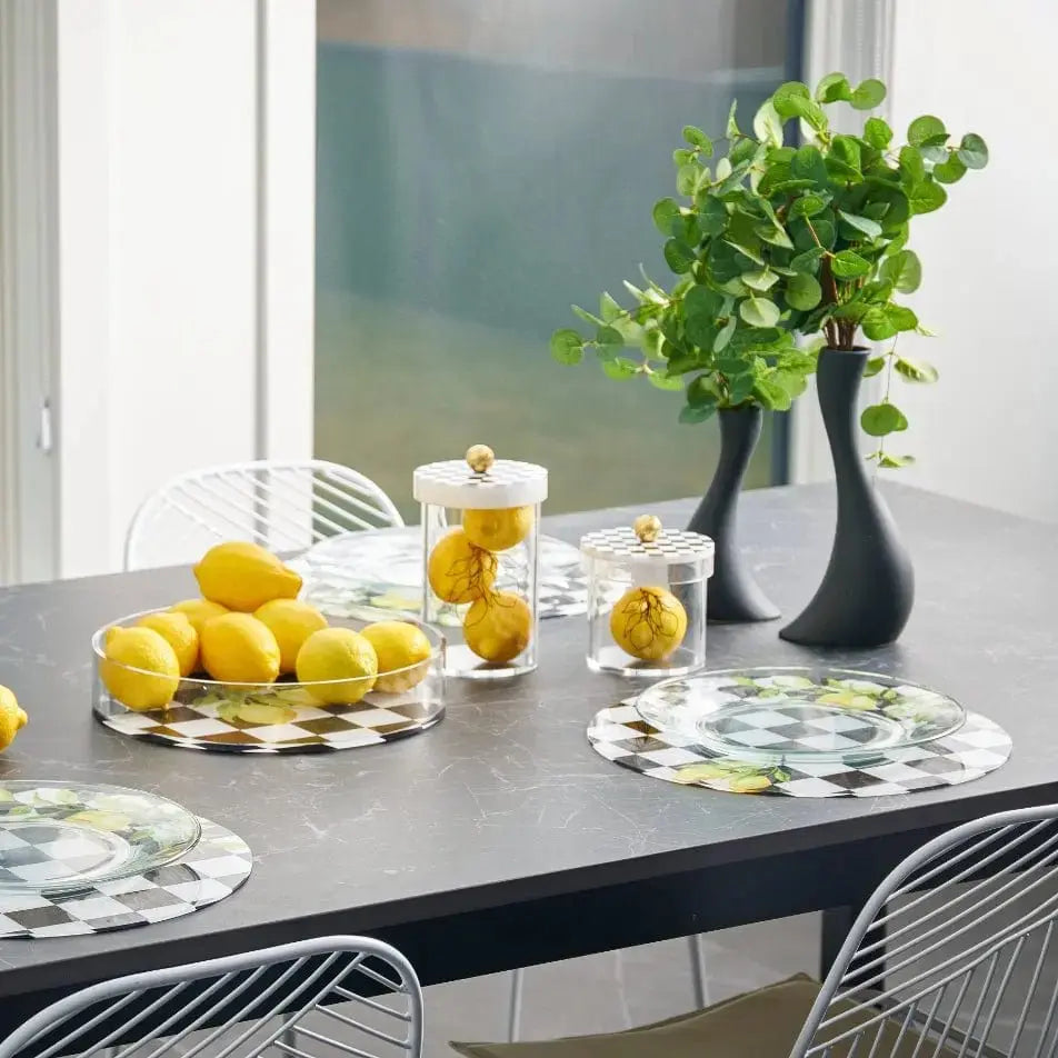 Onyx Lemona cylinder canisters displayed on a marble table with lemons and fresh herbs, ideal for kitchen storage and entertaining.