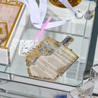 Partly finished Diamond Art dreidel card for Chanukah (חנוכה) with applicator pen, gem tray, and dreidels on a Lucite tray