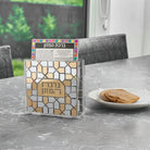 A DIY Lucite bencher holder you build yourself with gold and silver mosaic pieces, with 4 Birchas Hamazon cards included. A hands-on Judaica project for kids. 