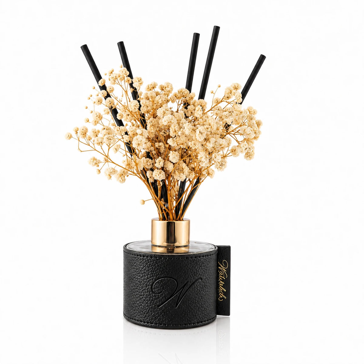 Black leatherette reed diffuser with black reeds, dried flowers and a gold collar