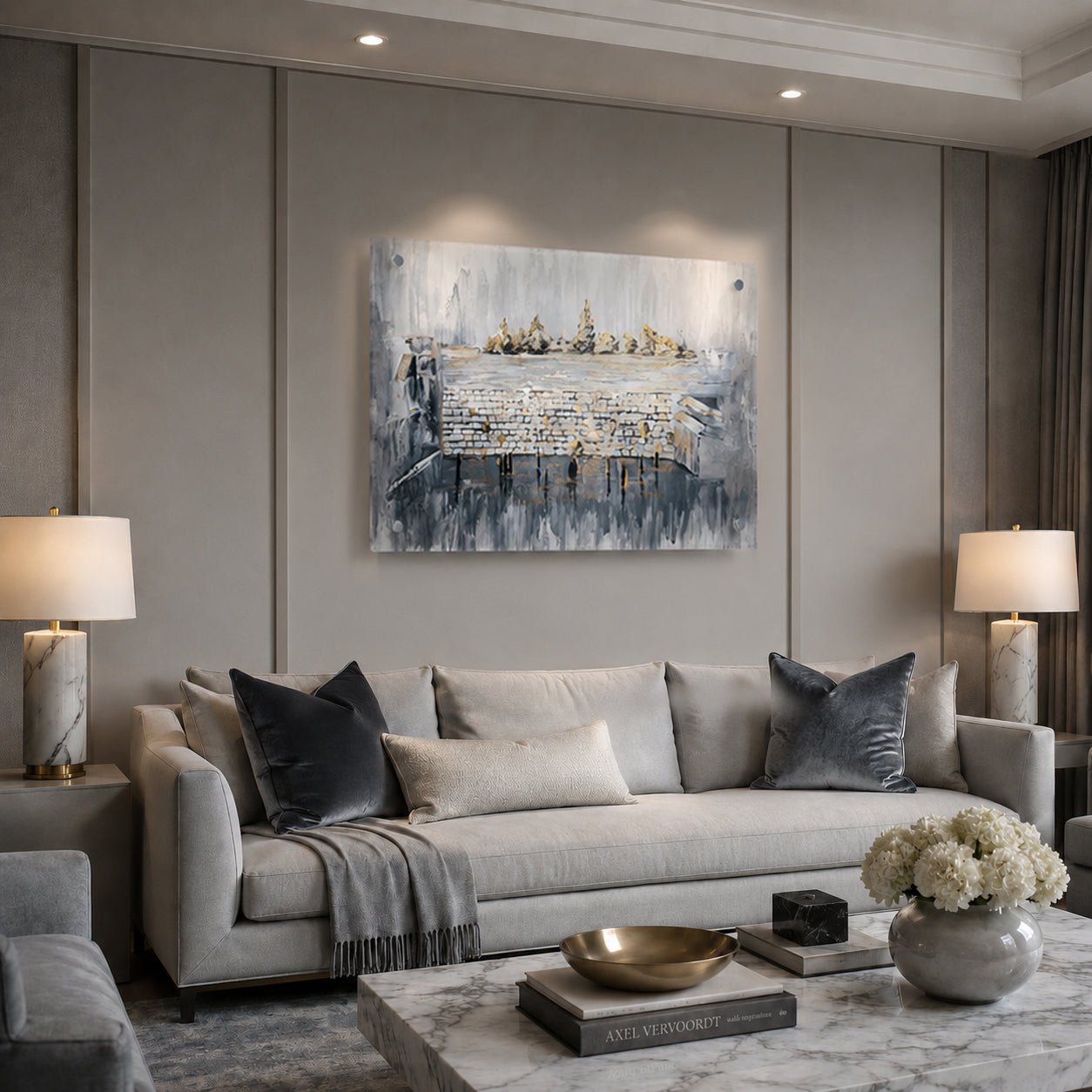 A modern living room featuring a large abstract canvas painting with blue, gray, and white tones of th ekosel , hung on a gray paneled wall above a light gray sofa.