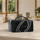 Plush fur, a sweeping leather loop and embossed Hebrew lettering give this Sukkos esrog case its look. Black and navy. 